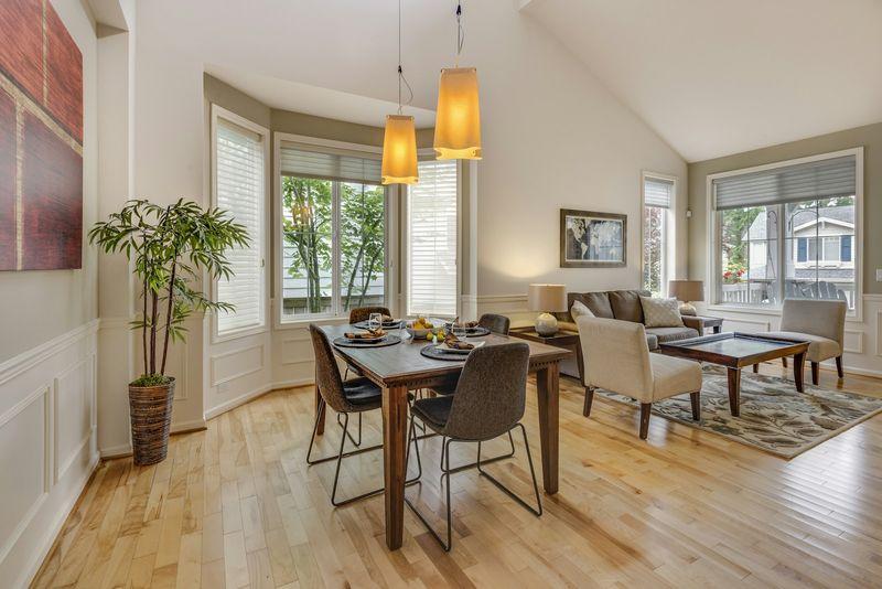 Sunlit dining room with wide light oak hardwood flooring