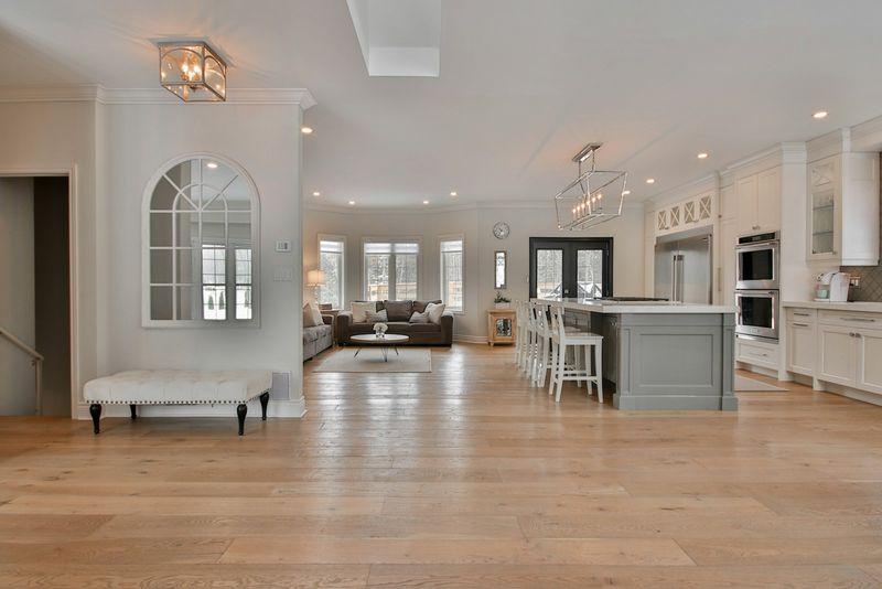 Open-plan living space with wide light oak hardwood flooring