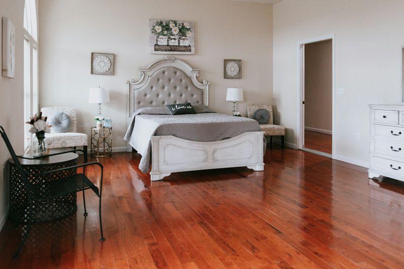 Bright bedroom with polished cherry hardwood floor in foreground